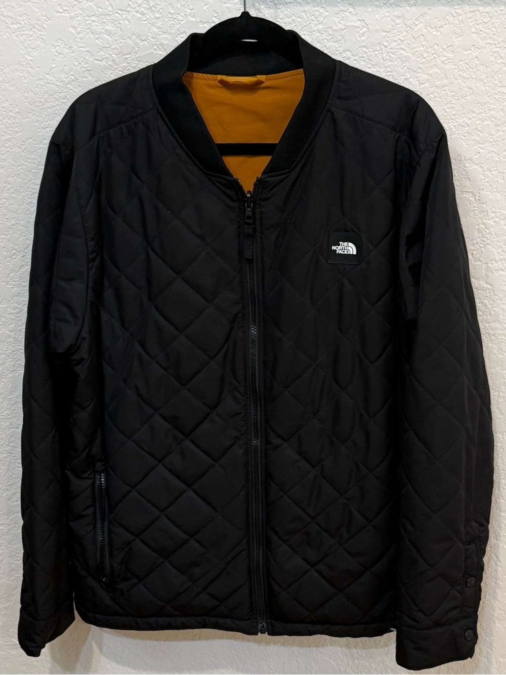 The North Face Men's Jester Reversible Bomber Jacket, Black with Gold Interior